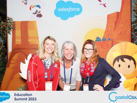 Trellis team poses in front of Salesforce education summit backdrop